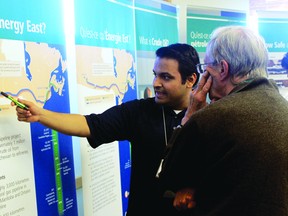 A TransCanada employee explains the Energy East pipeline project to an attendee at the energy company’s Kenora open house, Monday, Sept. 16.