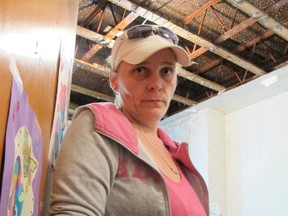Theresa Woodhouse stands in her apartment at 36 Nelson St. in Kingston. Despite complaints over nearly four years, little has been done to fix the deteriorating conditions.
Paul Schliesmann/The Whig-Standard