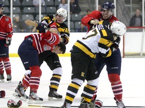 Kingston Frontenacs Warren Steele (77) fights Oshawa Generals Jake Harrison while Kingston's Slater Doggett  takes on Oshawa's Patrick Hamilton in Ontario Hockey League exhibition play at the Rogers K-Rock Centre on Sept. 6. Thanks to rule changes, fighting was down almost 25% in the OHL last season. (Ian MacAlpine/The Whig-Standard)