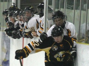 Two participants battle along the boards during the inters-quad game held Sunday at 2 p.m.