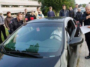 A group of second-year students in Police Foundations at Loyalist College in Belleville fill out driver's license information following a highway-traffic-act related training scenario held at the community college Thursday morning. 
JEROME LESSARD The Intelligencer