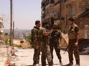 Syrian army troops loyal to President Bashar al-Assad, photographed in June overlooking rebel-held territory in the city of Aleppo.
