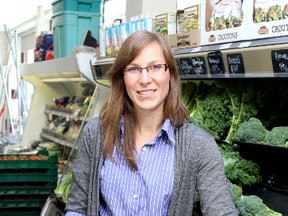 Rachael Goodmurphy, public health dietician for Kingston, Frontenac and Lennox and Addington Public Health, looks for food on their Nutritious Food Basket list at John's Delicatessen & Meat Market on Thursday. 
IAN MACALPINE/KINGSTON WHIG-STANDARD/QMI AGENCY