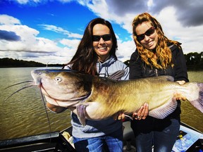 Michelle Trudeau, left, and Ashley Rae with Michelle’s 27-pound channel cat caught on the Red River in Manitoba. (Supplied photo)