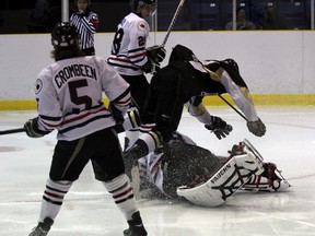 Nathan Savage of the LaSalle Vipers goes up and over Sarnia Legionnaires goaltender Sean Parker during the second period of their game on Thursday night. The Legionnaires would win the game 7-6 in a shootout. SHAUN BISSON/ THE OBSERVER/ QMI AGENCY
