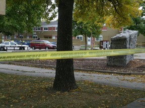 Police monitor the scene of a homicide on Robinson Street north of Dufferin Avenue in Winnipeg's North End Friday, Sept. 20, 2013.