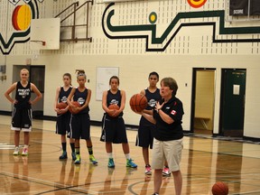 Allison McNeill does some on-court work with local players who were at her clinic to help demonstrate the drills. The former head coach of the Canadian women’s national basketball team stressed keeping basketball fun for young players by ensuring that everyone has a ball during practice and everyone gets playing time in games, among other methods. In order to grow the game, players need to have fun at the youth levels to have the will to continue on to higher levels of basketball. - Thomas Miller, Reporter/Examiner