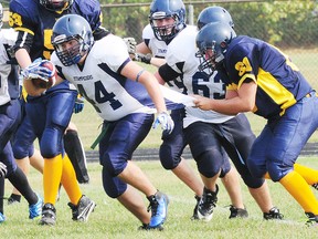 Strathroy's Christian VanCleef tries to take down Parkside running back Hayden Archibald by the shirttail as the junior teams tangled in TVRA junior football action Friday at PCI. Archibald picked up a lot of tough yards for the Stampeders, but the visiting Saints prevailed 30-14.  R. MARK BUTTERWICK / St. Thomas Times-Journal / QMI AGENCY