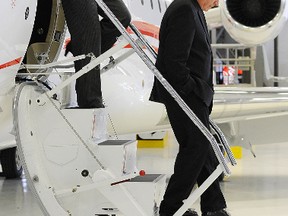 Ontario Premier Kathleen Wynne and MPP Jeff Leal inspect an airplane during a tour of Flying Colours, a global aviation services company, on Tuesday, April 2, 2013 at the Peterborough Airport.  (Clifford Skarstedt/QMI AGENCY)