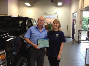 Karla Duek Thiessen, president of the Sherbrook Sharks Swim Club, presents a certification of appreciation to Peter Solilak and the Birchwood Automotive group. The group provided a shuttle to get kids to practice after the Sherbook Pool suddenly shut down last fall due to structural issues.