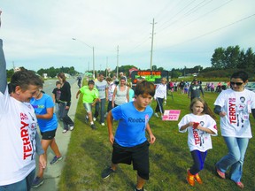 Sue Healey officially starts the 33rd Annual Terry Fox Run’s three-kilometre portion Sunday morning along Broadway. Roughly 140 participants raised $8,200 through the event, a total up $400 from 2012. Jeff Tribe/Tillsonburg News