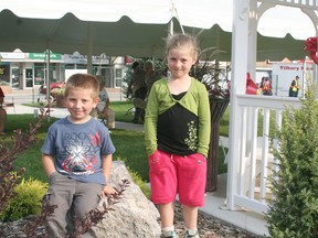 Caynen Sheehan, 4, and his sister, Jazzmin, 5, enjoy the new Carrick's Corner Park in Tilbury during the grand opening celebration held on Sept. 20. They were at the park with their father, Dan. The park was named for the late Chuck Carrick, a former long-time Tilbury mayor and businessman and is located at the corner of Queen and Prospect streets. The park was formerly a vacant lot and is the highlight of a downtown revitalization project. Carrick's Corner features beautiful landscaping, benches and a gazebo and has turned into a meeting place and landmark for local residents and visitors.