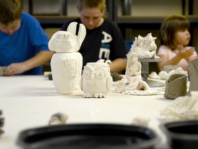 Examples of pottery created at the CORE Arts and Culture Centre are on display while young visitors try their hand at making their own pottery.