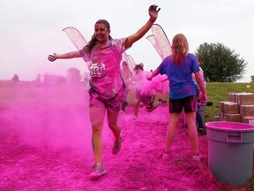 Runners pass through one of four dye stations along Saturday’s five-kilometre Run or Dye event at Fort Henry. (Elliot Ferguson The Whig-Standard)