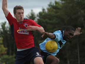 Kingston FC defender Ryan McCurdy tries to stop York forward Richard West takes a pass on the way to scoring his team's first goal in the first half of Sunday's game. (Elliot Ferguson The Whig-Standard)