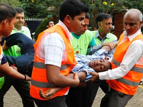 Volunteers at the MP Shah hospital assist a man whose relative was killed in Saturday's attack at the Westgate shopping mall in Nairobi September 22, 2013. (REUTERS/Thomas Mukoya)