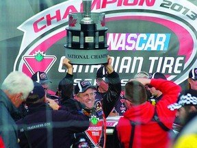 Milverton's Scott Steckly raises the championship trophy after clinching the title by winning the final race of the NASCAR Canadian Tire Series season Sunday at Kawartha Speedway in Fraserville, near Peterborough. (Dale Clifford, QMI Agency)