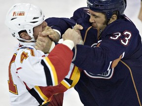 Steve MacIntyre is shown in a preseason fight with Flames tough guy Raitis Ivanans ina 2010 pre-season game. (Edmonton Sun file)