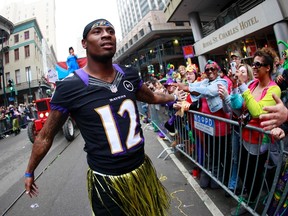 Baltimore Ravens wide receiver Jacoby Jones parades down St. Charles Avenue on Mardi Gras Day in New Orleans February 12, 2013. (REUTERS/Sean Gardner)