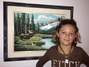 Lemonee Kostynuk, of Innisfree, standing beside her late Grandpa, ElginKostynuk’s painting. His works will be displayed at the art and quilt display on Saturday, Sept.28.