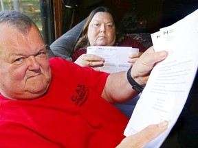 Martin and Wendy Vermeer, at their home south of Tweed, hold the forms and letters they've received regarding Martin's Old Age Security Pension. The Canadian Forces veteran was expecting his first payment July 31 but has yet to receive it, leaving the couple unable to pay their bills. - LUKE HENDRY The Intelligencer