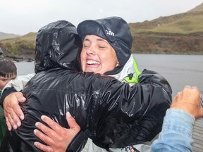 British adventurer Sarah Outen celebrates as she arrives in Adak in the Aleutian Islands September 23, 2013 to become the first person to ever row solo from Japan to Alaska. (REUTERS/James Sebright/Handout via Reuters)