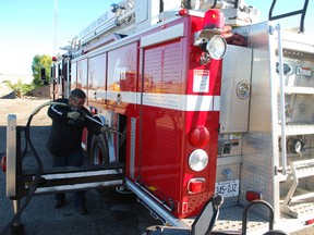 Elmore Best blasts dry ice pellets at the frame of a St. Thomas fire truck on Tuesday. Best was using a dry ice cleaning procedure that removes dirt and old undercoating so the truck's undercarriage can be re-coated.