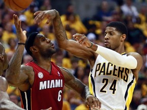 Indiana Pacers' Paul George (R) passes over Miami Heat's LeBron James in Game 6 of their NBA Eastern Conference Final basketball playoff series in Indianapolis, Indiana June 1, 2013. (REUTERS/Brent Smith)