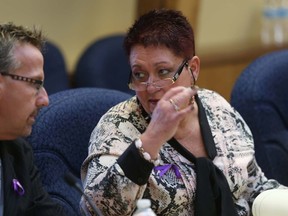 Coun. Jackie Denyes speaks with Coun. Egerton Boyce during Monday's city council meeting at city hall.