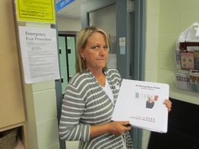Cheryl Surridge, with the Ontario Early Years Centre at Lambton College, holds a staff guide for No Wrong Door, an initiative aimed at making it easier for families to access services for young children in Sarnia-Lambton. PAUL MORDEN/ THE OBSERVER/ QMI AGENCY