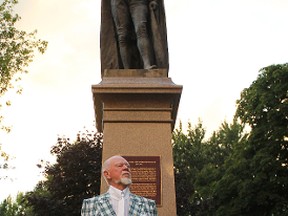 Don Cherry leads a Sir John A. Macdonald walking tour through Kingston as he stands in front of a statue of Canada's first prime minister in City Park.