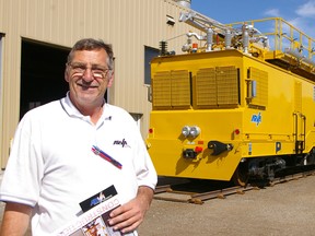 Wayne O'Shell, Arva Industries sales representative for rail, and a $2 million (U.S.) maintenance-of-way vehicle the St. Thomas company built for NJ Transit. Arva hopes the unit will open doors for additional sales to other rail operators. Eric Bunnell/QMI Agency/Times-Journal