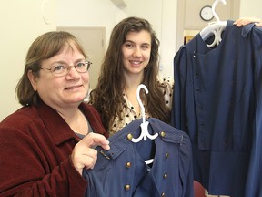 Kathy Karkut, left, and Diana Gore from the Museum of Health Care hold uniforms that will be part of a workshop on Saturday devoted to helping people properly preserve and prepare family treasures for long-term storage.
Michael Lea The Whig-Standard