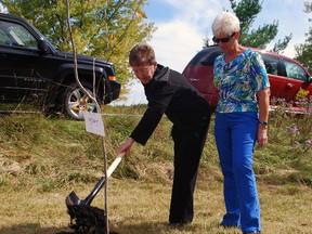 Brenda Sawyer, left, shovels earth near a yellow birch tree planted in memory of her husband Roy Sawyer at Kettle Creek Conservation Authority's Community Forest near St. Thomas on Wednesday. The forest was established in 1999 and honours weddings, births, retirements and the loss of loved ones. Standing with Sawyer is Roy's sister, Lorraine Smith.