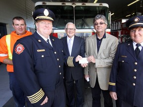 From left, Tillsonburg First Class Firefighter Barry Lasook, Chief Jeff Smith, Mayor John Lessif, Union Gas Utility Services Manager (Simcoe Branch) Guy Howell, and Nelly Green, Fire Protection Advisor, Office Of The Fire Marshal, share in the announcement of a $5,000 grant to Tillsonburg’s fire service through Project Assist Wednesday afternoon at Tillsonburg’s fire station. Project Assist is a partnership between the Fire Marshal's Public Safety Council and Union Gas. Jeff Tribe/Tillsonburg News