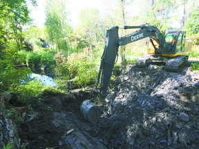 Kirwin & Oatman excavator operator George Mills works on a third sediment trap along Lisgar Creek last week, just south of North Street, adjacent to the Trans Canada Trail. Jeff Tribe/Tillsonburg News