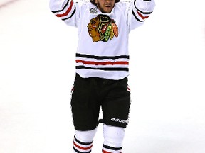 Former Sarnia Sting forward Daniel Carcillo lifts the Stanley Cup on June 24 after his Chicago Blackhawks beat the Boston Bruins. The NHL season is just around the corner and Observer sports reporter Shaun Bisson predicts the Hawks will finish second in the west this year. (AP Photo)