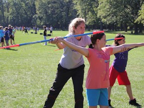 Canadian track and field athlete Jillian Drouin works with St. Anne's students McKalyn Moran, 11, foreground, and Tia Burgin, 12, at Canatara Park Friday, Sept. 27, 2013. The sister of Olympian Derek Drouin taught javelin during the second annual Sports Dy Multicultural Elementary Games. (BARBARA SIMPSON, The Observer)