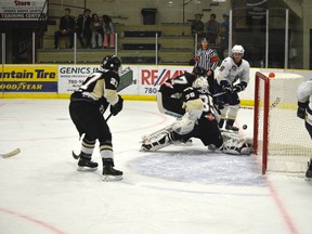 Saints forward Riley Simpson chips home a bad-angle goal on the power play against Bonnyville on Sept. 20. - Thomas Miller, Reporter/Examiner