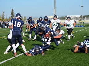 Jassen Brown wraps up a Ross Sheppard running back during the Panthers 65-7 win on Sept. 19. The Panthers defence, aside from one big play, was nearly flawless. - Thomas Miller, Reporter/Examiner