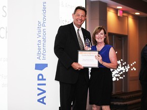Minster of Tourism, Parks and Recreation, Richard Starke, presents the award to Cathy Fournier, of the Stony Plain and District Chamber of Commerce. - Photo Supplied