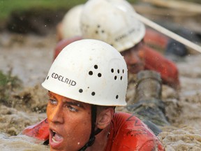 First-year cadets at the Royal Military College of Canada in Kingston crawl through a water filled trench during Friday's annual first year obstacle course.
Elliot Ferguson The Whig-Standard