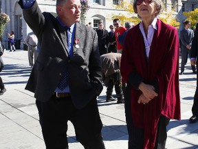 Arthur Milnes of the Sir John A. Macdonald Bicentennial Commission points out some of the buildings surrounding Market Square to Chief Justice Beverley McLachlin during Friday's In Sir John A.’s Footsteps walking tour.
Elliot Ferguson The Whig-Standard