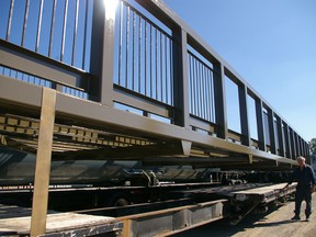 Phil Evely, of Yarmouth Group Inc. metal fabricators, looks over 88-foot bridge built by company for Pinafore Park Memory Garden waterfall feature, and on flatbed and ready to be installed Monday.