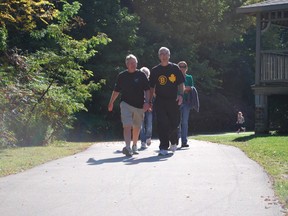 Ross Tucker, left, and retired St. Thomas Fire Chief Bob Barber lead a group of about 150 participants in Believe in a Cure: A Walk for Lou Gehrig's Disease at Pinafore Park in St. Thomas on Saturday, Sept. 28, 2013. The walk is a fundraiser for research to find a cure for the disease, also known as  Amyotrophic lateral sclerosis (ALS). The event hoped to raise $15,000 this year. Ben Forrest/QMI Agency/Times-Journal