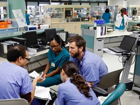 Doctors confer in the neonatal intensive care unit of the Holtz Children's Hospital at Jackson Memorial Hospital in Miami September 30, 2013. (REUTERS/Joe Skipper)