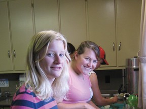 Linnea Nonkes and Melissa chop and blanch zucchini before freezing it.