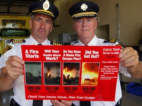 St. Thomas Fire Chief Rob Broadbent, left, and Central Elgin Fire Chief Don Crocker hold a poster for a public safety campaign promoting smoke alarms and home fire escape plans, and offering free home fire safety inspections by departments in St. Thomas and throughout Elgin.