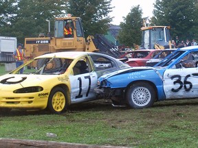 Cars driven by Nick Ganhadeiro of Dutton, left, and Jeff Walker of West Lorne collide in one of the heats at the Wallacetown Fair demolition derby Sunday. It was one of the fair's most popular events, attracting a big crowd to watch the smash-'em-up action.