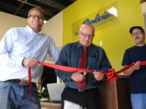 Parkview Alliance Church’s Lead Pastor Bryce Ashlin-Mayo holds the ribbon while Vermilion’s mayor Bruce Marriott cuts the ribbon to celebrate opening of the new youth drop in centre.